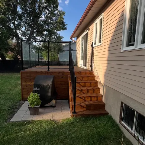 Newly built deck stairs and railing on a single-family home