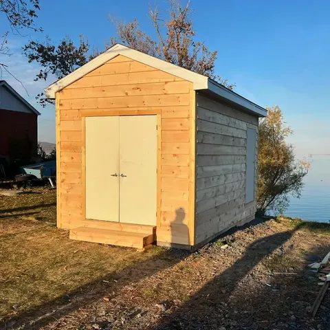 Finished cedar shed with double doors facing the lake