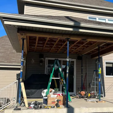 Covered-deck roof shored with temporary posts while the columns are replaced